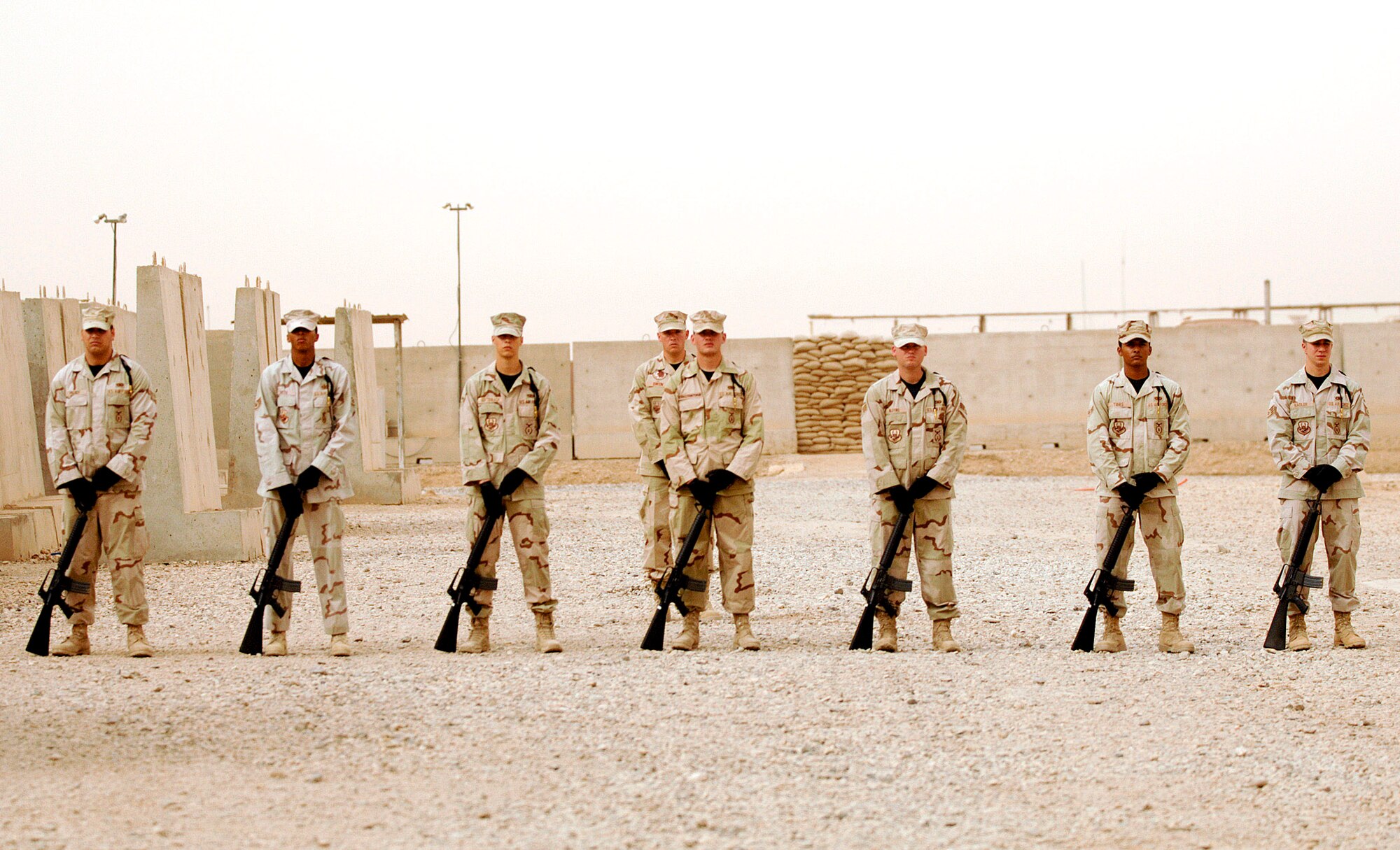 Honor guard members from the 407th Expeditionary Group at Ali Air Base, Iraq, prepare for a 21-gun salute during a fallen Airmen ceremony May 28 in remembrance of Staff Sgt. John Self at Ali Air Base. Sergeant Self, a security forces member assigned to the 732nd Expeditionary Security Forces Squadron at Camp Bucca, Iraq, was killed May 14 by an improvised explosive device while on patrol. (U.S. Air Force photo/Master Sgt. Robert W. Valenca)