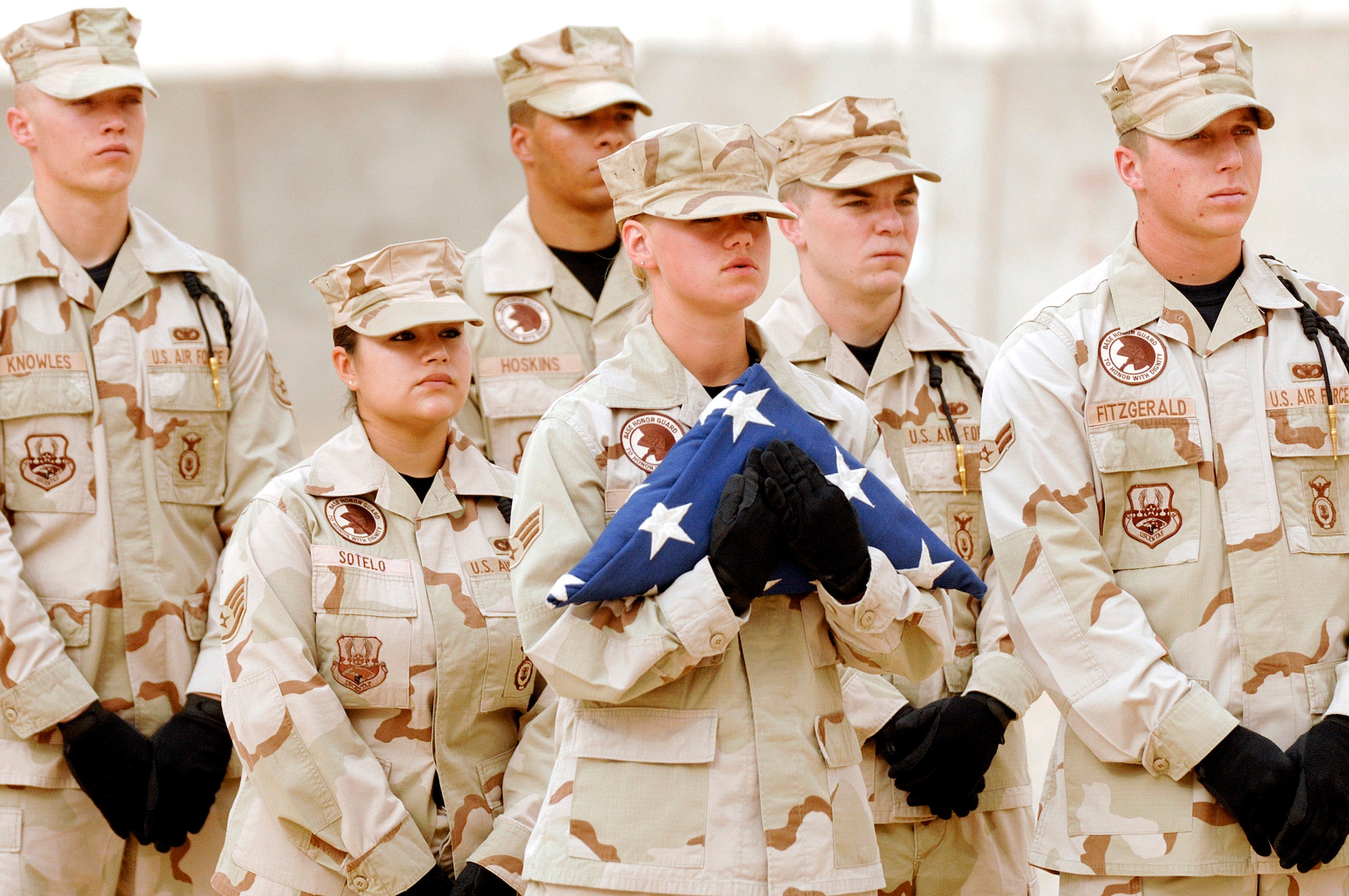 Honor guard members from the 407th Expeditionary Group at Ali Air Base, Iraq, wait to fold the flag during a fallen Airmen ceremony May 28 in remembrance of Staff Sgt. John Self. Sergeant Self was a security forces member assigned to the 732nd Expeditionary Security Forces Squadron at Camp Bucca, Iraq, and was killed May 14 by an improvised explosive device while on patrol. (U.S. Air Force photo/Master Sgt. Robert W. Valenca)