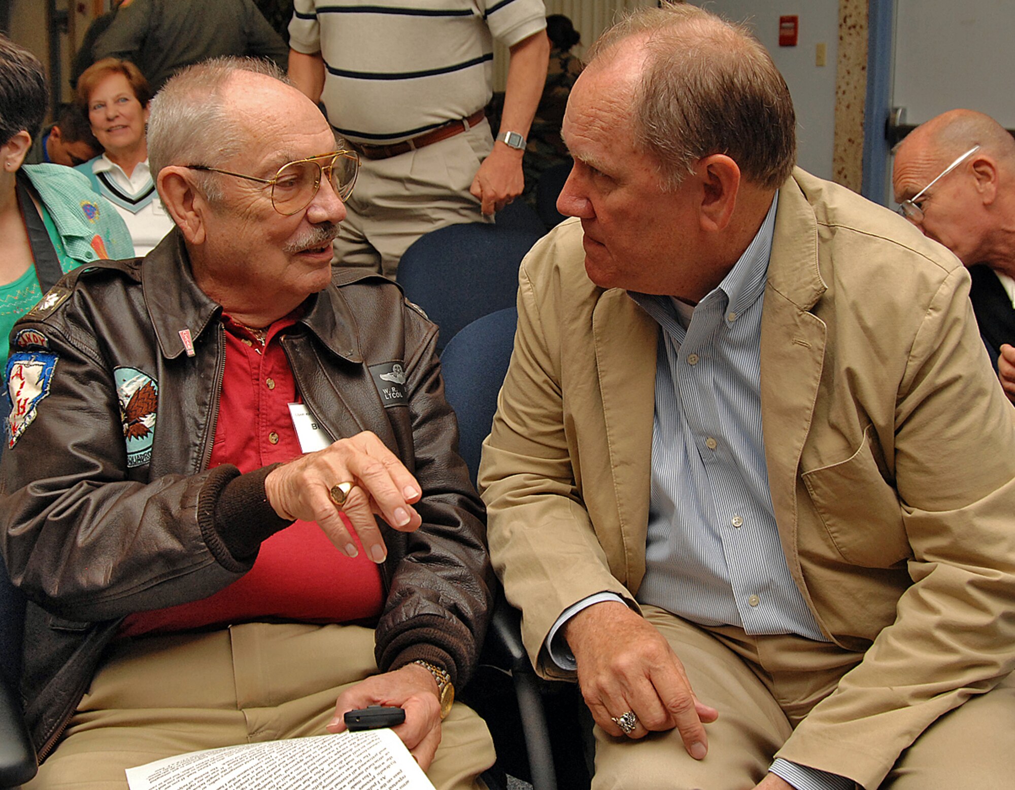 Bill Buice and Phil Jennings, members of the Society of Combat Search and Rescue and former pilots, talk about their experiences in Laos. U.S. Air Force photo by Todd Berenger