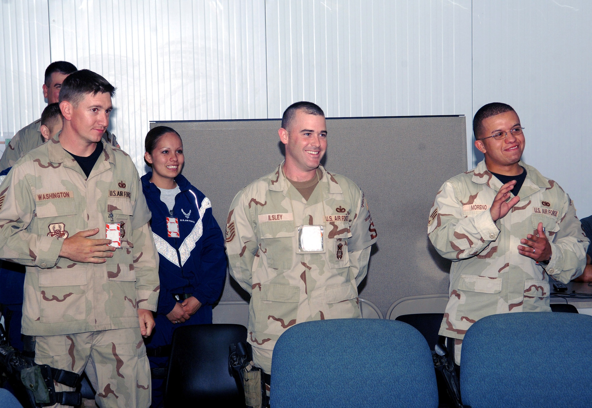 Senior Airman Carlos Moreno (far right) watches the video teleconference screen as he and his fiancee, Carolina, exchange vows during a VTC wedding May 26 from Bagram Air Base, Afghanistan, to Vandenberg Air Force Base, Calif. Airman Moreno is assigned to the 455th Expeditionary Security Forces Squadron. Members of the 455th ESFS were present to witness the ceremony and show their support. Airman Moreno is deployed from the 30th Security Forces Squadron at Vandenberg AFB. (U.S. Air Force photo/Staff Sgt. Craig Seals)