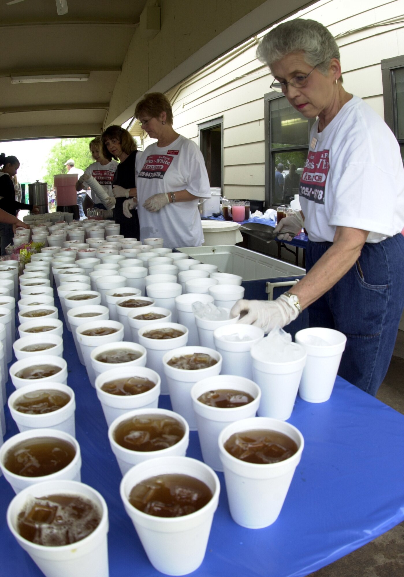 Volunteers served thousands of cups of iced tea and pink lemonade at the Goodfellow Appreciation Day picnic May 19. (U.S. Air Force photo by Airman 1st Class Luis Loza Gutierrez)