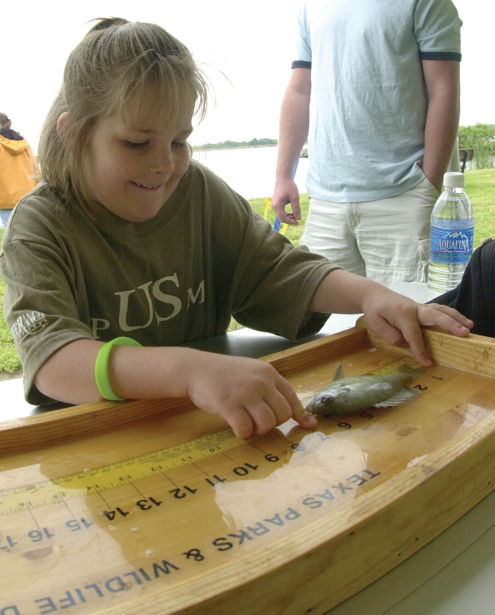 Seven-year-old Melissa Noble measures her latest catch, a 6-inch sunfish. Melissa was one of dozens of young anglers who competed in the 2007 America’s Armed Forces Kids’ Fishing Derby Saturday at the Goodfellow Recreation Camp at Lake Nasworthy. (U.S. Air Force photo by Airman 1st Class Luis Loza Gutierrez).