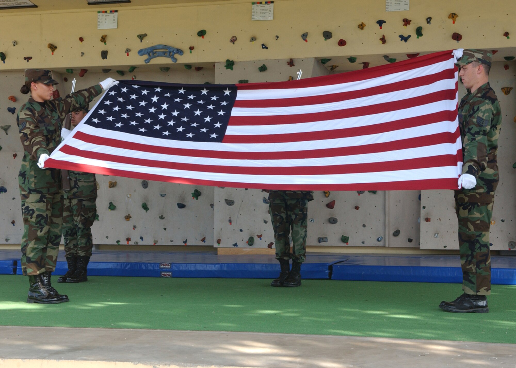 Members of the Honor Guard fold and retire the flag during the Memorial Day formal retreat ceremony.  The ceremony was held to honor fallen military members.  (U.S. Air Force photo by Airman 1st Class Tiffany Colburn) 