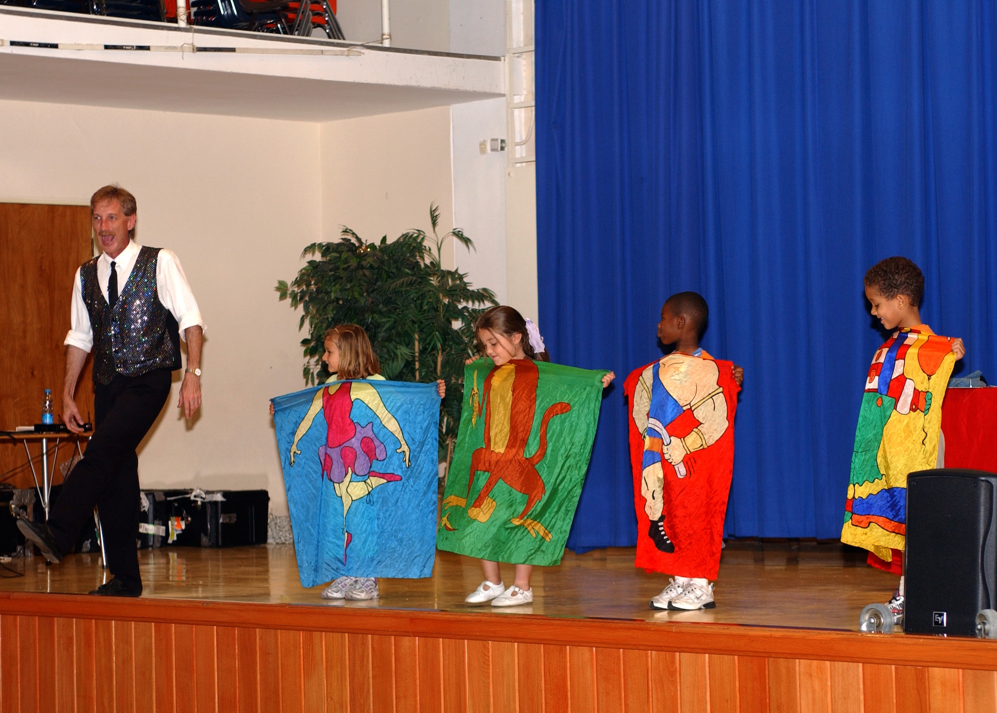(from left to right) Rodney Kelley, Sloane Youtsey, Tricitti Mamac, Keondre Covington, and Elijah Barbin dance on stage during the magic show at Incirlik's Elementary School May 24. Mr. Kelley was just one of the magicians to perform for the children that day. (U. S. Air Force photo by Airman First Class Timothy A. Taylor)           