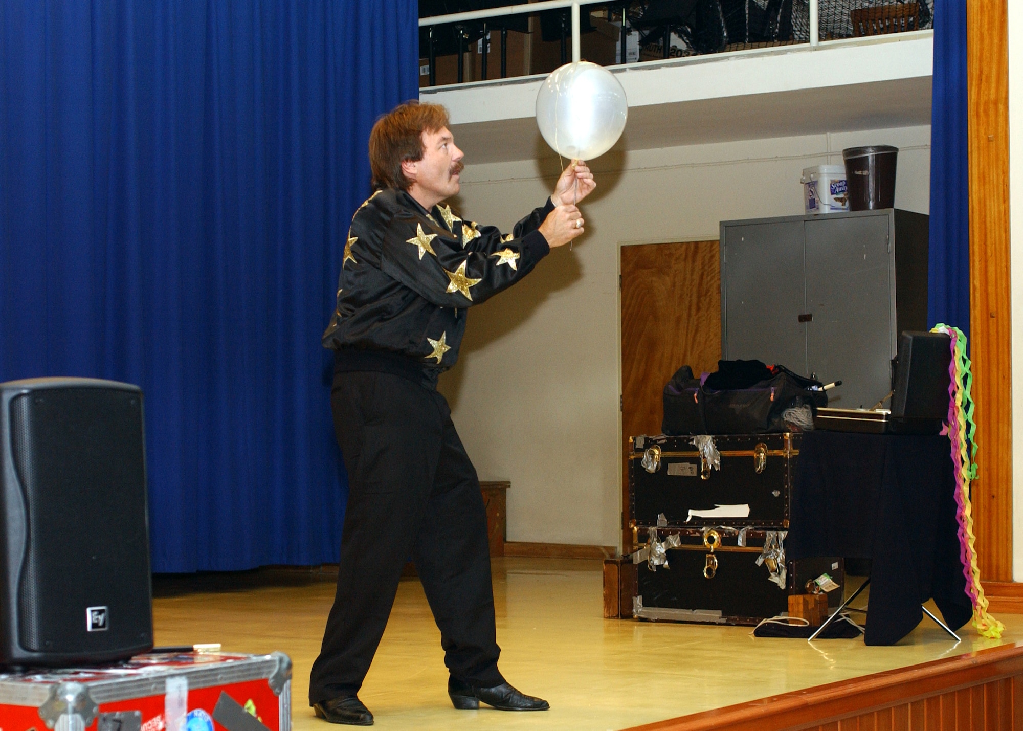 Rick Moore of "Moore Magic" performs his magic balloon trick on stage for Incirlik's Elementary School May 24. (U. S. Air Force photo by Airman First Class Timothy A. Taylor)           