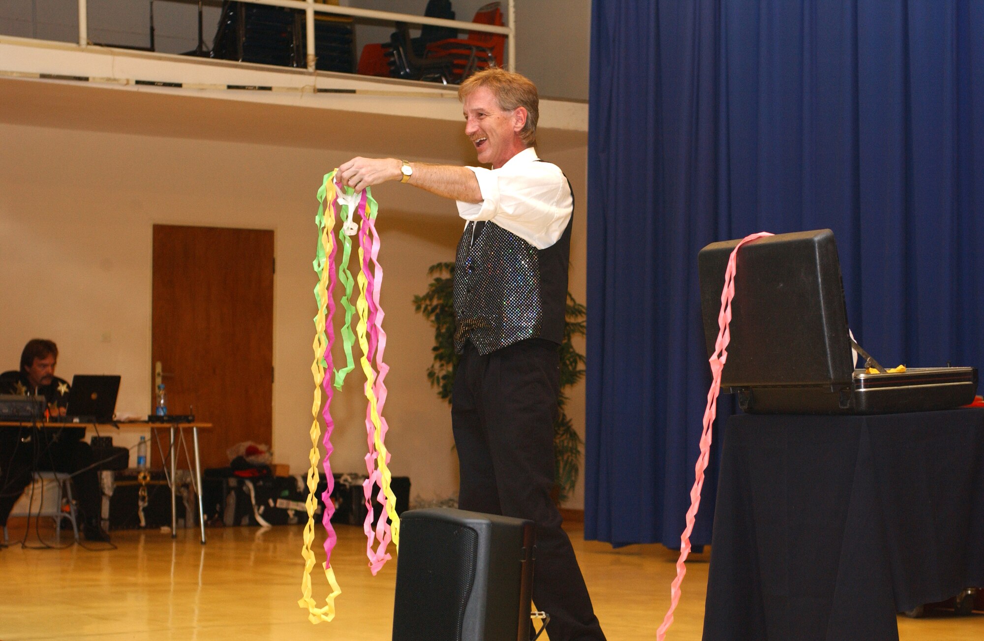 Rodney Kelley of "Moore Magic" performs a paper magic trick on stage during the magic show at Incirlik's Elementary School May 24. (U. S. Air Force photo by Airman First Class Timothy A. Taylor)           