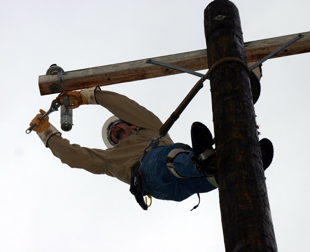 Brian Brown, a lineman from the civilian team, attempts to relocate a lightning arrestor during the Linemen's Rodeo May 19.  The civilian team traveled from Indiana to participate in the event. (U.S. Air Force photo/Staff Sgt. Tonnette Thompson)