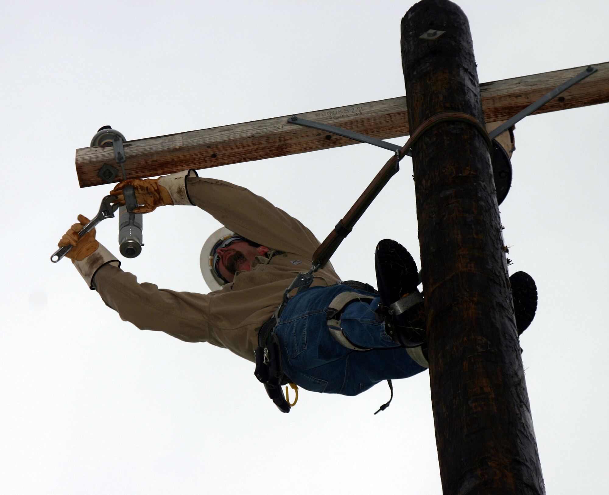 Brian Brown, a lineman from the civilian team, attempts to relocate a lightning arrestor during the Linemen's Rodeo May 19.  The civilian team traveled from Indiana to participate in the event. (U.S. Air Force photo/Staff Sgt. Tonnette Thompson)