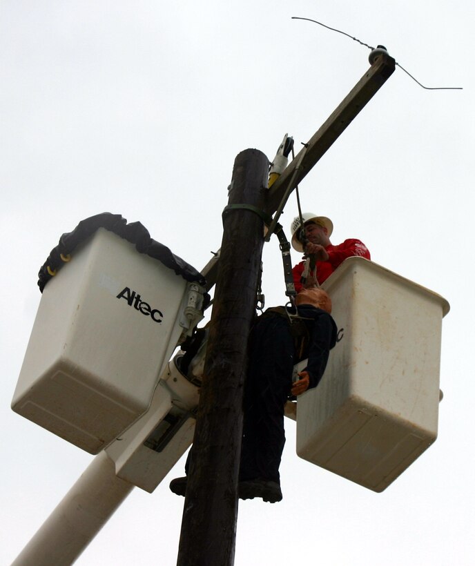 Tech. Sgt. Kristian Schroer, 366th Training Squadron, sets up the hurt man rescue challenge for the next contestant at the Linemen's Rodeo May 19. (U.S. Air Force photo/Staff Sgt. Tonnette Thompson)