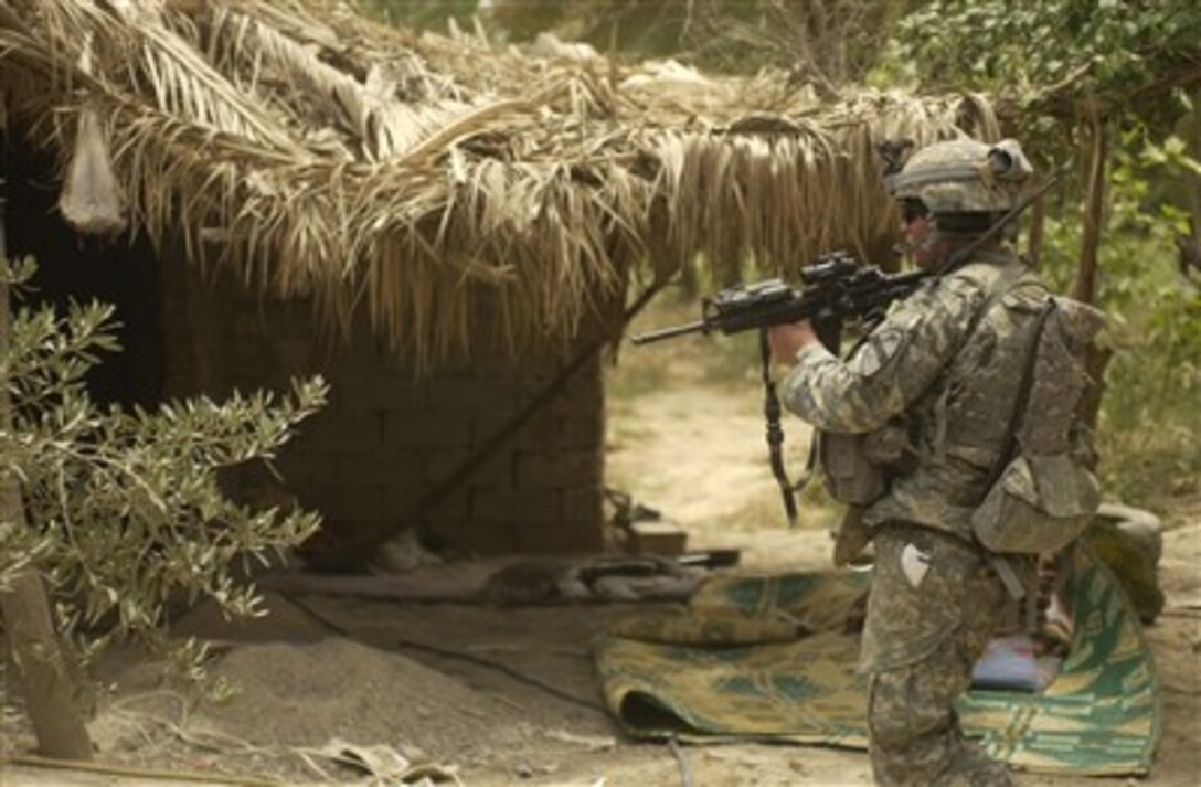 A U.S. Army soldier from the 1st Battalion, 12th Cavalry Regiment clears a suspected al Qaeda prison camp south of Baqubah, Iraq, on May 27, 2007.  U.S. soldiers liberated 41 men from the camp and provided immediate medical attention to them.  