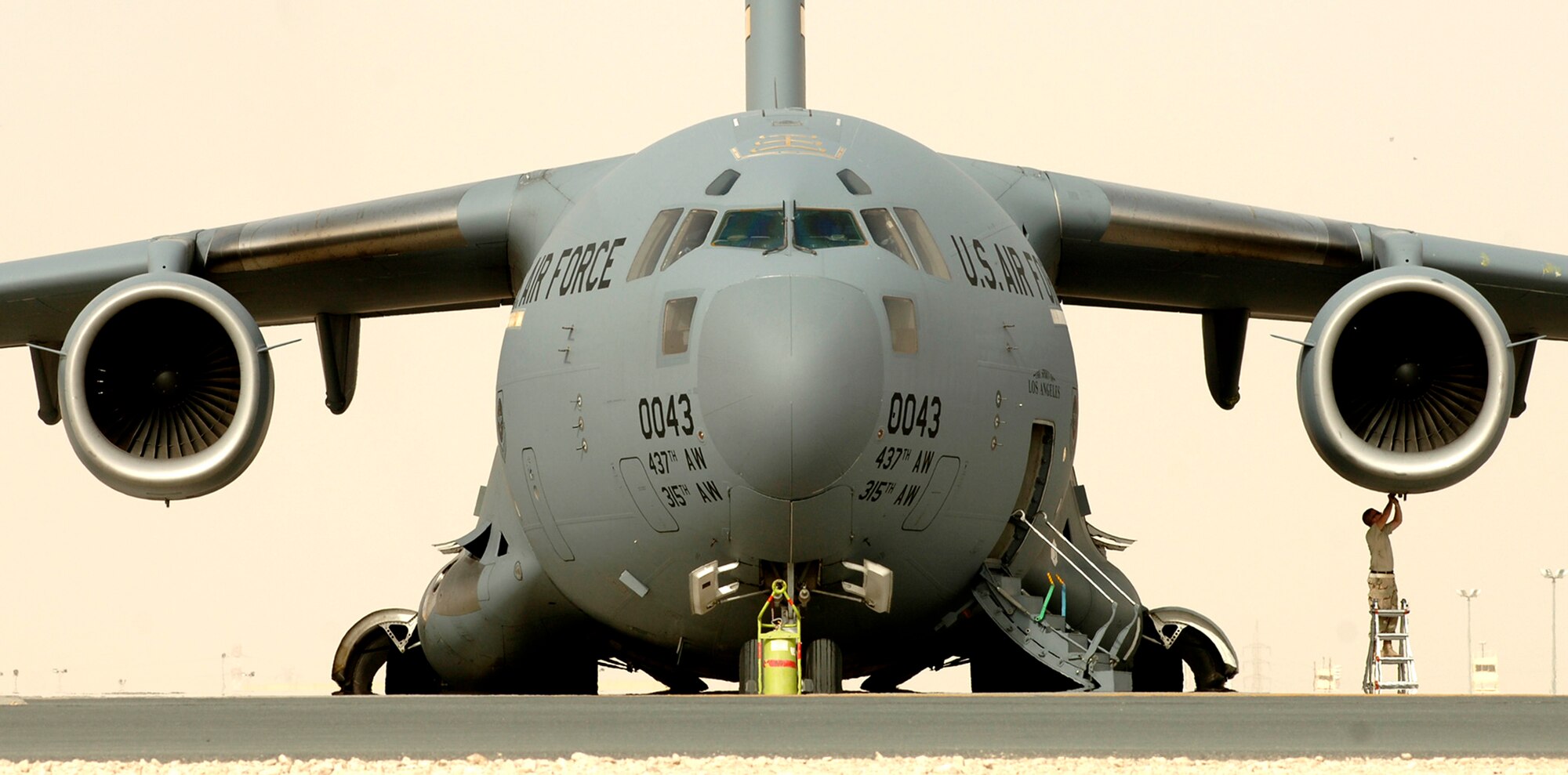 A C-17 Globemaster maintainer prepares his aircraft for take off in support of operations in Iraq.  C-17's provid intra-theater heavy airlift support.  (U.S. Air Force photo/Tech. Sgt. Cecilio M. Ricardo Jr.)