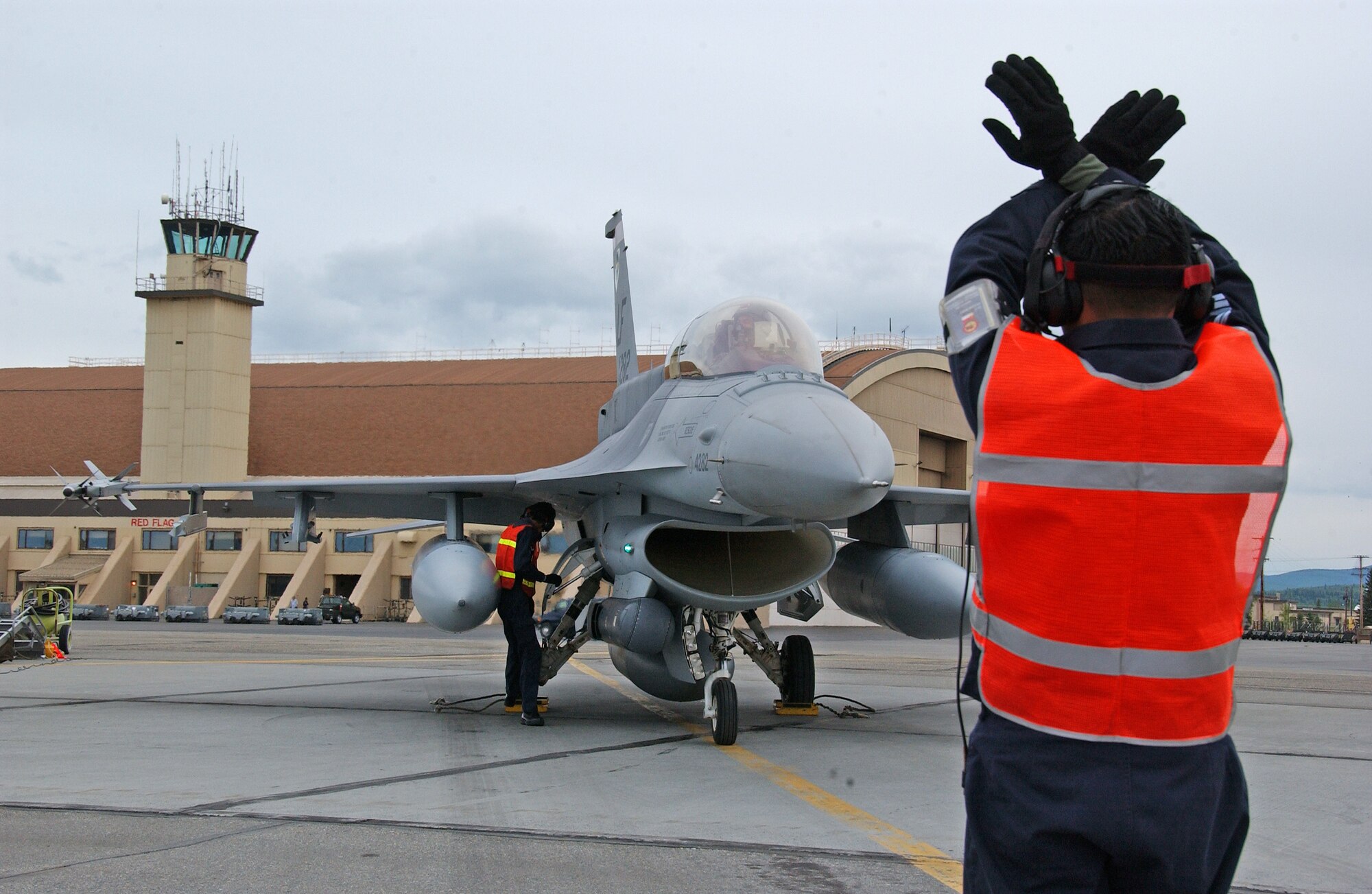 EIELSON AIR FORCE BASE, Alaska--A Republic of Singapore air force crew chief marshals a Singapore F-16 after landing here May 30 for Red Flag-Alaska 07-2. Red Flag-Alaska, a series of Pacific Air Forces commander-directed field training exercises for U.S. forces, provides joint offensive counter-air, interdiction, close air support, and large force employment training in a simulated combat environment. (U.S. Air Force photo by Senior Airman Justin Weaver).                     