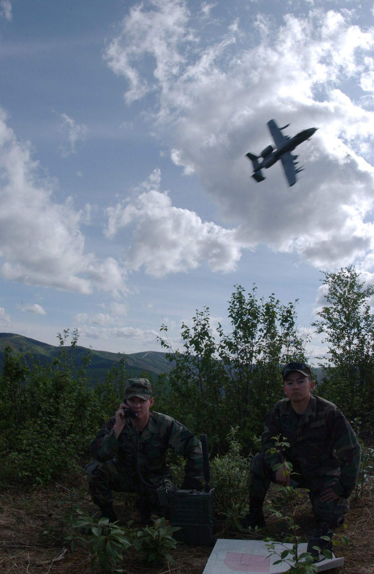 EIELSON AIR FORCE BASE, Alaska -- Senior Airman John Tranum and Airman 1st Class Steve Vonack, both 3rd Air Support Operations Squadron tactical air control party, use a PRC-117 Multi-band Tactical Radio to communicate with the aircrafts during an exercise May 29 on the Pacific Alaska Range Complex. 3rd ASOS members coordinate, request, and control close air support, theater airlift, and reconnaissance. (U.S. Air Force Photo by Airman 1st Class Jonathan Snyder) 