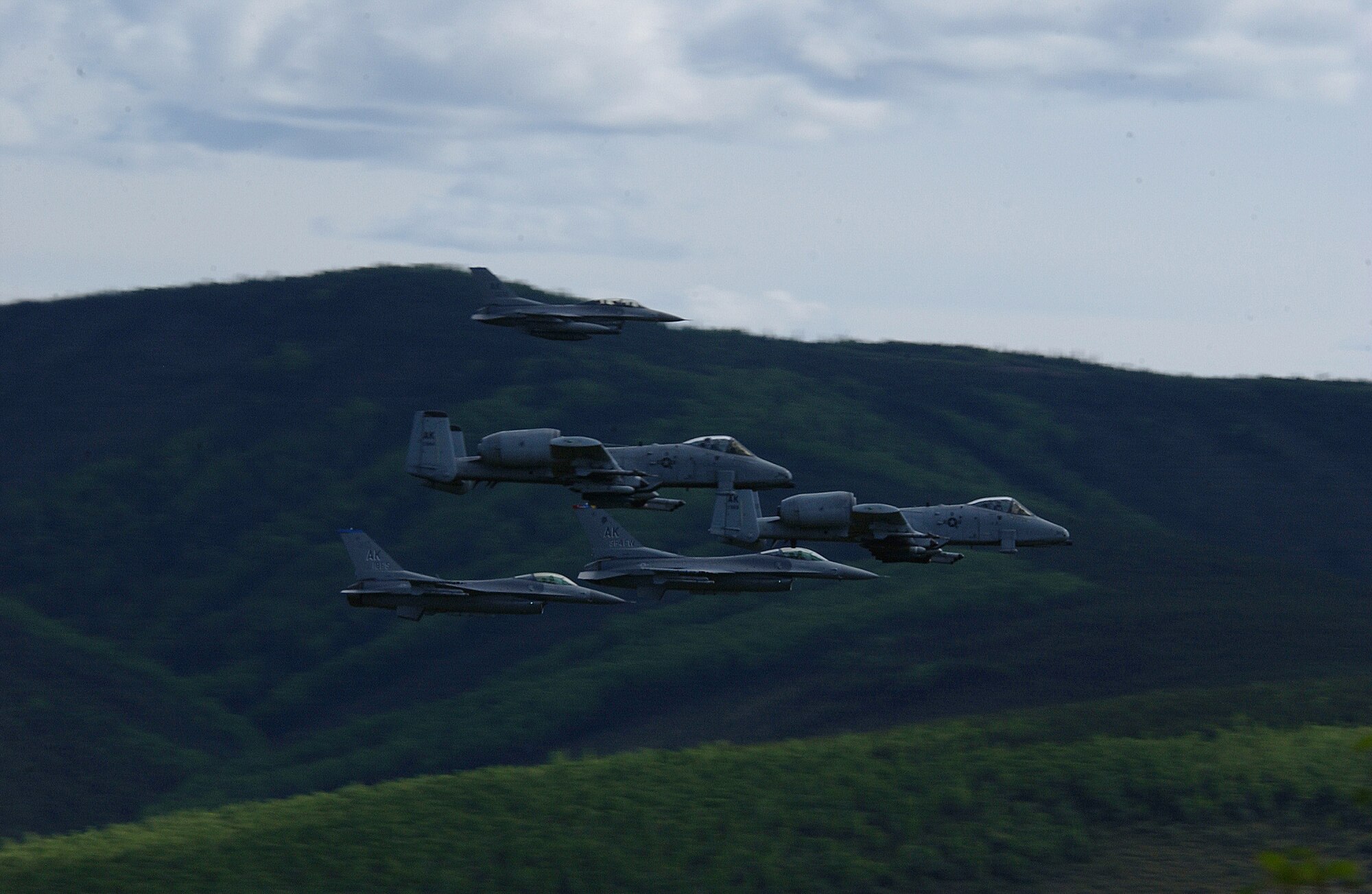 EIELSON AIR FORCE BASE, Alaska -- Two A/OA-10 Thunderbolt II aircrafts from the 355th Fighter Squadron and three F-16 Fighting Falcons aircraft from the 18th Fighter Squadron fly in formation over the Pacific Alaska Range Complex May 29. The 18th FS conducts air operations for combat-ready F-16 aircraft, working closely with the 355th FS to provide close air support, forward air control (airborne), battlefield air interdiction, and offensive counter air. (U.S. Air Force Photo by Airman 1st Class Jonathan Snyder) 