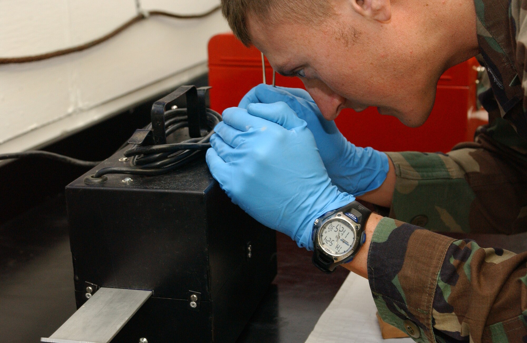 EIELSON AIR FORCE BASE, Alaska -- Senior Airman John Lind, 354th Logistics Readiness Squadron fuels management flight, performs a color in particulate assessment May 24 in the fuels management laboratory.  Airman Lind is looking at a reading of a sample 300 mL of fuel under an ultraviolet light to detect water in the fuel.  A sample reading must have under 10 parts per millionth of water to ensure that the fuel is safe for aircraft use. (U.S. Air Force photo by Senior Airman Rachel Walters)
