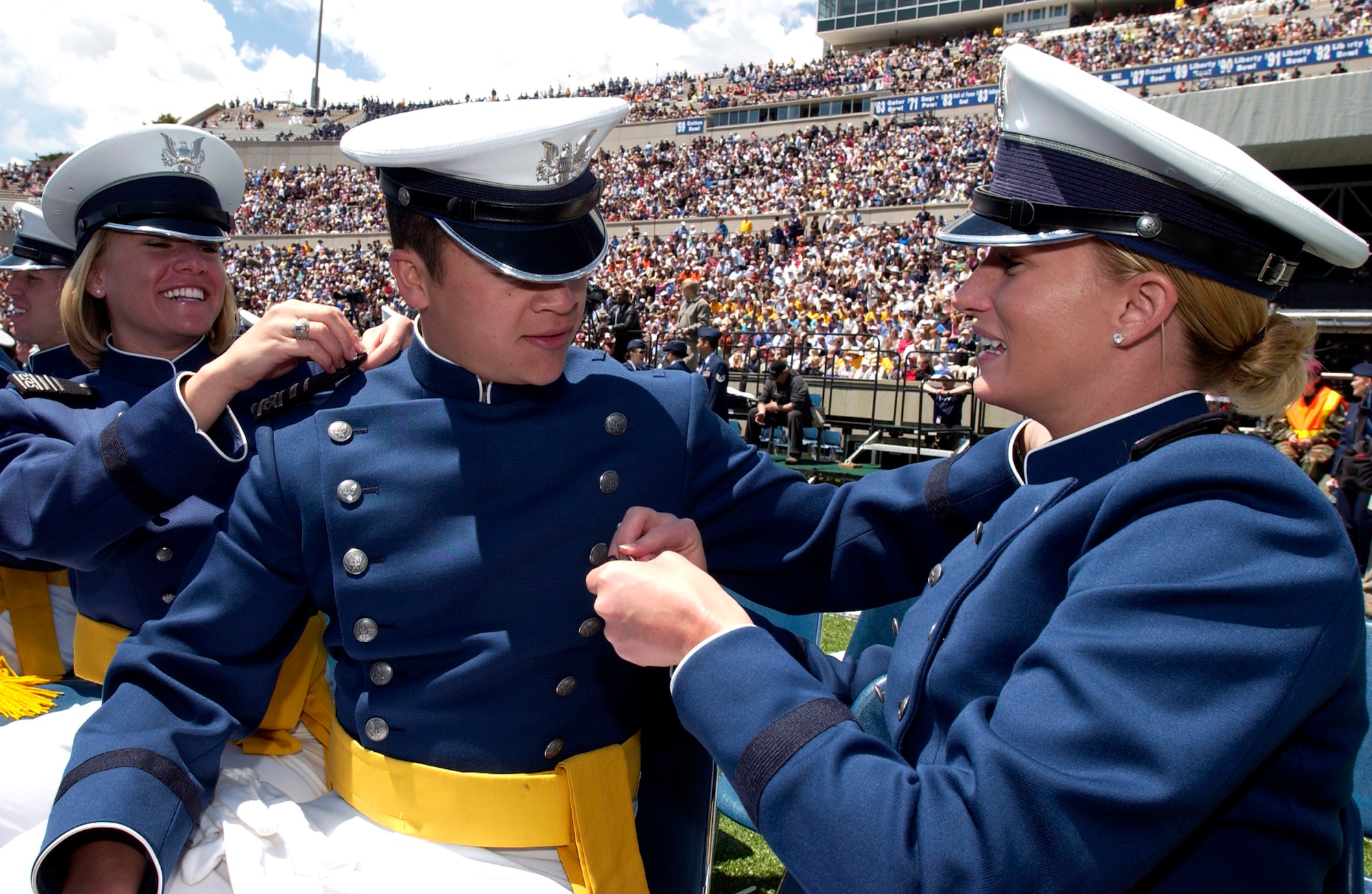 Newly minted 2nd Lieutenants Catlin Butterfield, David Drennan and Kandi Hendershied pin second lieutenant bars on each other during the 2007 U.S. Air Force Academy graduation ceremony May 30 in Colorado Springs, Colo. (U.S. Air Force photo/Mike Kaplan) 