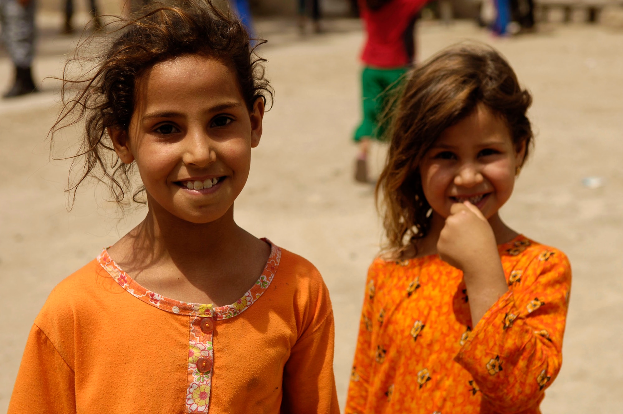 Iraqi children are all smiles May 24 after receiving gifts from the Iraqi National Police in Al Furat, Iraq. During a recent humanitarian mission, U.S. servicemembers worked with the Iraqi police to distribute school supplies, toys and treats to Iraqi children. (U.S. Air Force photo/Master Sgt. Brian L. Boone)