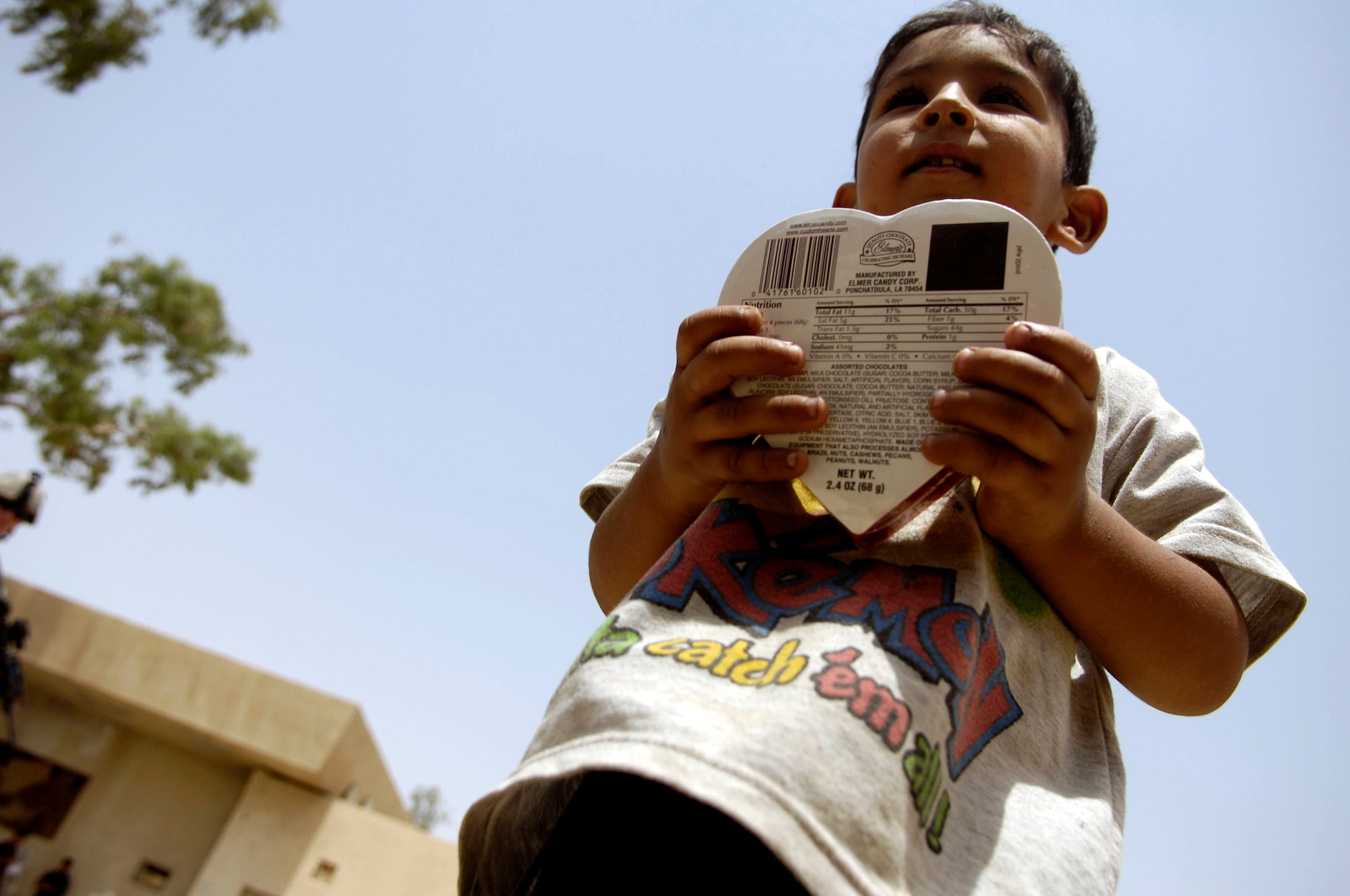 An Iraqi child clutches a box of chocolates he received as a gift May 24 from the Iraqi National Police in Al Furat, Iraq. During a humanitarian mission, U.S. servicemembers worked with the Iraqi police to distribute school supplies, toys and treats to Iraqi children. (U.S. Air Force photo/Master Sgt. Brian L. Boone)