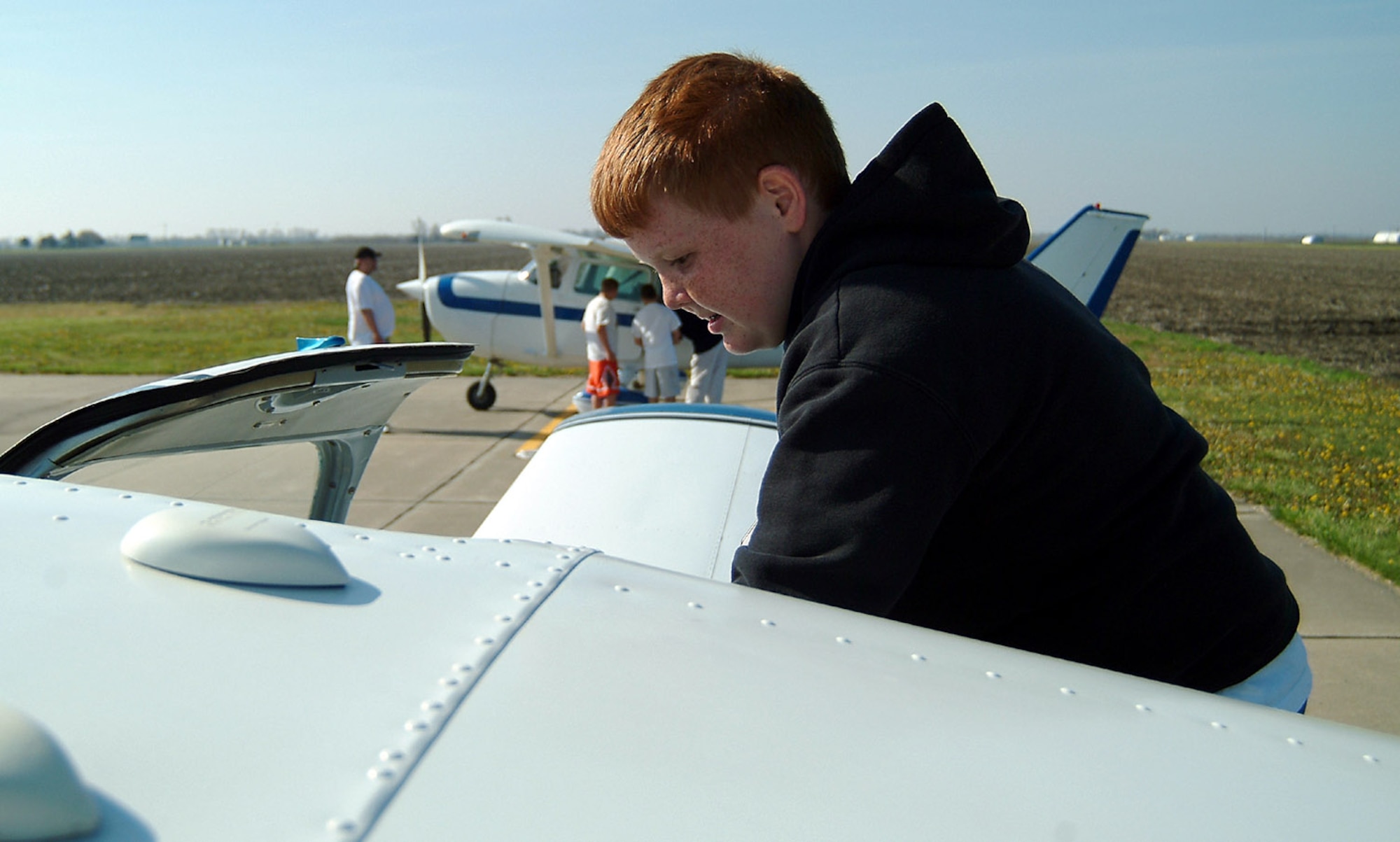 As a reward for successful completion of the 442nd Fighter Wing-sponsored Wright Flight mentoring program, Rory McGraw, a sixth-grade student at Hardin Central School in Hardin, Mo., climbs into an airplane for his flight over central Missouri at the culmination of this year's Wright Flight program. Area private pilots provided the flights to the students for free during the Wright Flight fly day April 21 at the airport in Carrollton, Mo. The 442nd FW is an Air Force Reserve Command A-10 Thunderbolt II fighter unit based at Whiteman Air Force Base, Mo. (U.S. Air Force photo/Master Sgt. Bill Huntington) 
