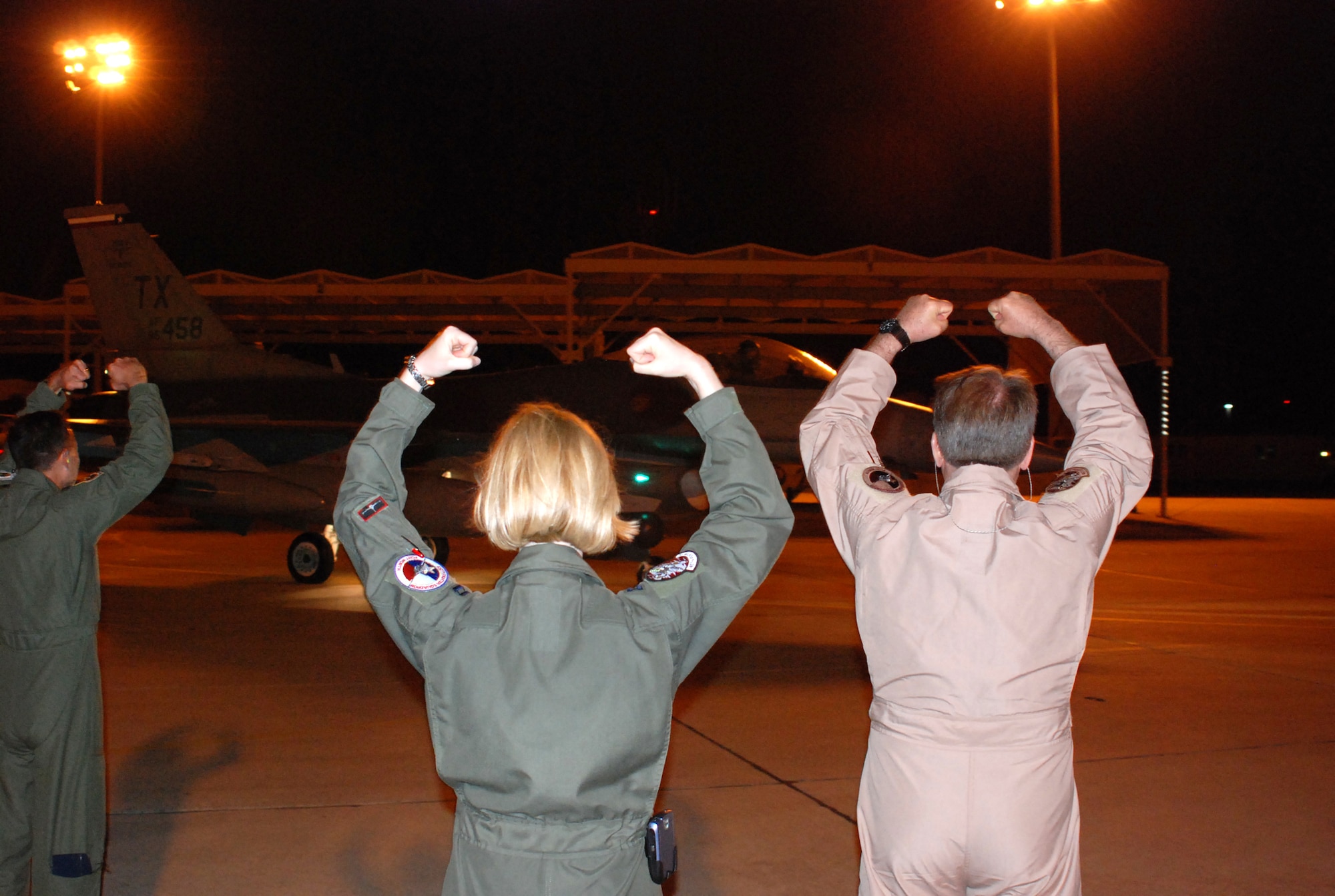 (right to left) Lt. Gen. John Bradley, commander Air Force Reserve Command, Capt. Shelia Demboski, executive assistant to the AFRC commander, and Col. Kevin Pottinger, 301st Fighter Wing commander, give a Spads send off to 457th Fighter Squadron pilots as they taxi down the Naval Air Station Joint Reserve Base Fort Worth flightline on their way to Southwest Asia. (U.S. Air Force Photo/Maj. Karl Lewis)