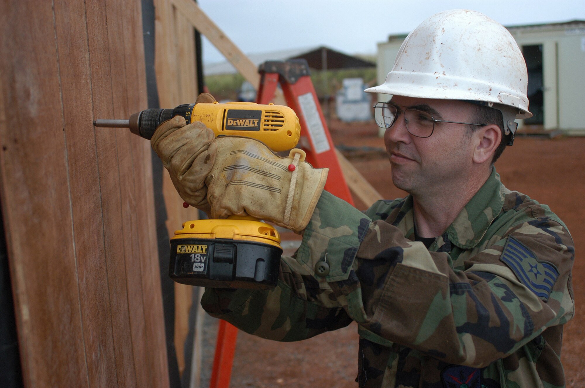Tech. Sgt. Mark Duran, 301st Civil Engineer Squadron electrical craftsman, secures wood panelling on a fabricated storage trailer. The twenty-person Air Force Reserve team spent two weeks on various projects which will be used to support and house elderly and disabled community members. (U.S. Air Force Photo/Tech. Sgt. Stephen Bailey)