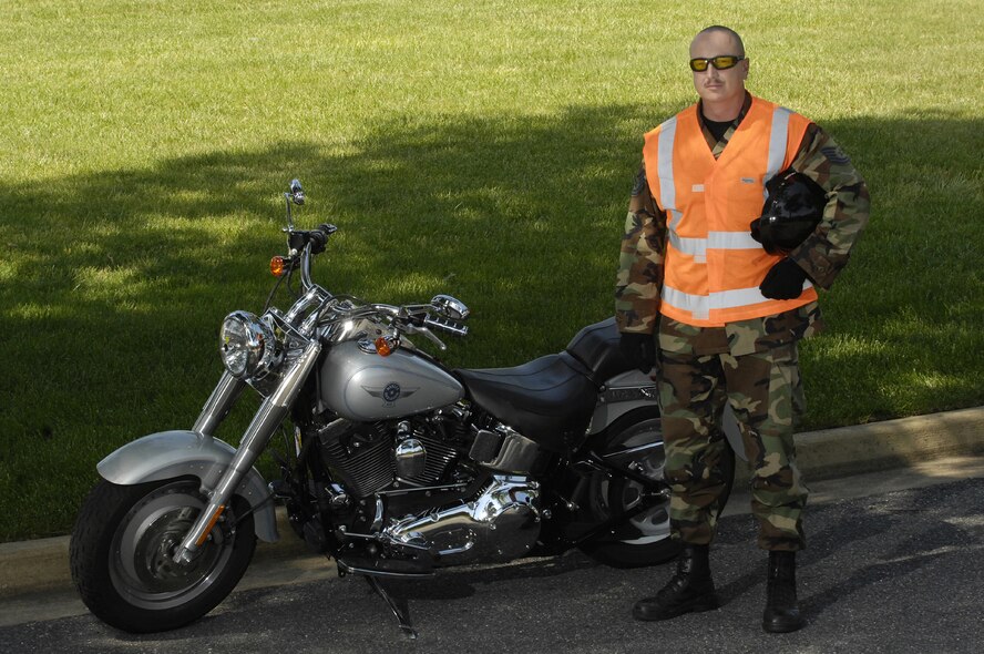 Tech. Sgt Lester Nelson, 11th Civil Engineer Squadron, shows the proper saftey equipment for motorcycle riding, bright vest, helmet, gloves, eye protection, long sleeved shirt and pants. (U.S. Air Force photo by Senior Airman Dan DeCook)