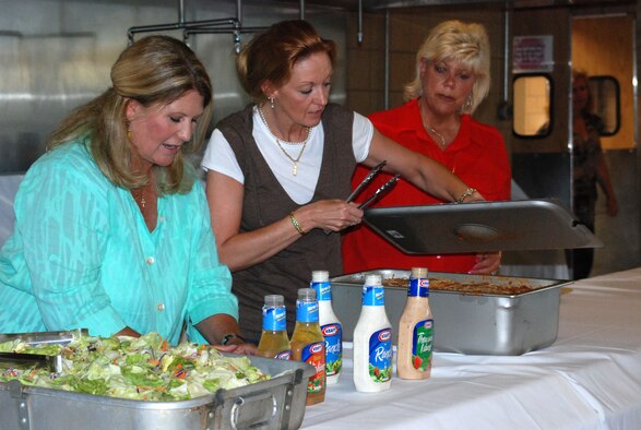 The 301st Maintenance Squadron spouses helped coordinated a farewell dinner for some of their Air Force Reserve deploying family members. Everyone dug in to prepare and serve dozens of families stationed at the Naval Air Station Joint Reserve Base Fort Worth, Texas. (U.S. Air Force Photo/Staff Sgt. Kristin Mack)