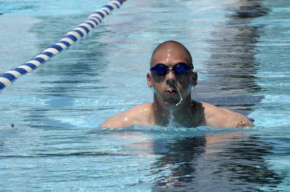 Marine Corps Staff Sgt Kenneth Andrews swims at the base pool during his lucnh break May 30. The base pool recently opened and will remain open until Labor Day. The pool is open Tuesday through Friday from noon to 7 p.m., Saturdays from 11 a.m. to 9 p.m. and Sundays 10 a.m. to 7 p.m. Swimming lessons are available Wednesday through Friday from 8 to 11 a.m. For more information, call (202) 767-9136. (U.S. Air Force photo by Senior Airman Dan DeCook)
