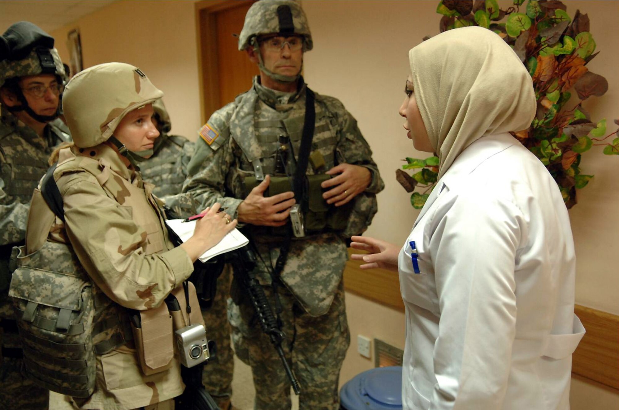 Capt. Samantha Elmore, holding pen at left, is shown during her deployment. (U.S. Air Force photo)