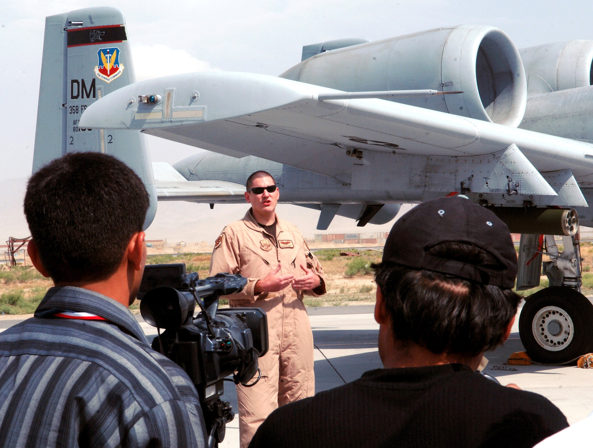 Capt. Doug Witmer, a 354th Expeditionary Fighter Squadron A-10 Thunderbolt II pilot, explains his job May 29 as a pilot and the role his A-10 plays in the close-air-support mission at Bagram Air Base, Afghanistan. Captain Witmer was one of several Airmen involved in a media event involving several local Afghan media aimed at informing them on the operations at Bagram and how the U.S. military is working alongside coalition partners to support and defend freedom in Afghanistan. (U.S. Air Force photo/Staff Sgt. Craig Seals) 