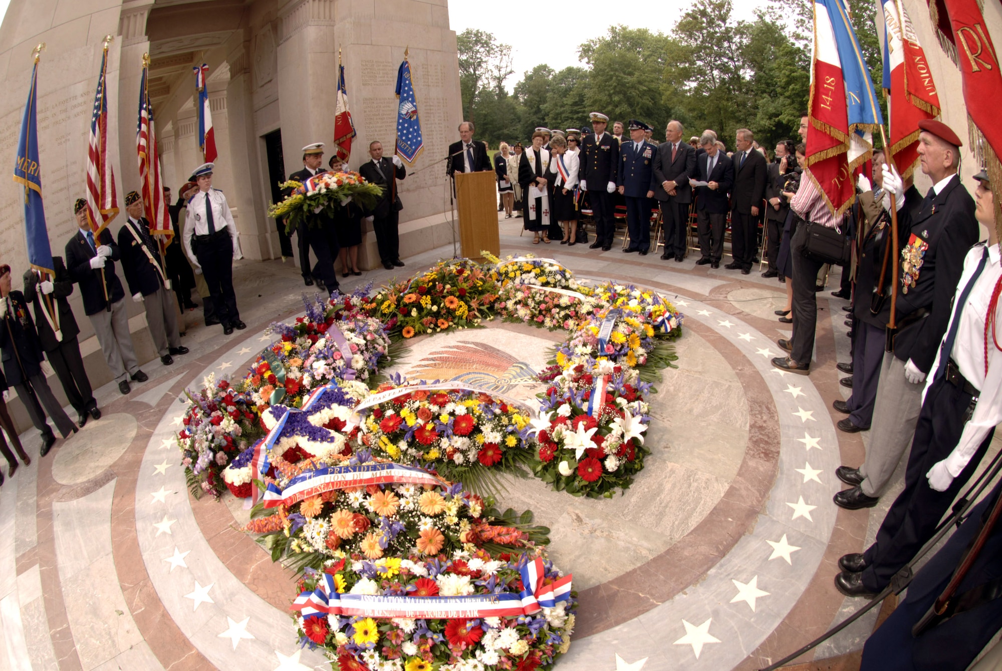 A final bouquet of flowers is added to a floral display during a ceremony at the Lafayette Memorial outside Paris to pay homage to the United States' first combat aviators who comprised the Lafayette Escadrille.  The all-American squadron of volunteers flew under the French flag during World War I where many gave their lives.  Among the dignitaries attending the ceremony were Air Force Chief of Staff Gen. T. Michael Moseley and his counterpart, French Gen. Stephane Abrial. (U.S. Air Force photo/Master Sgt. Scott Wagers)
