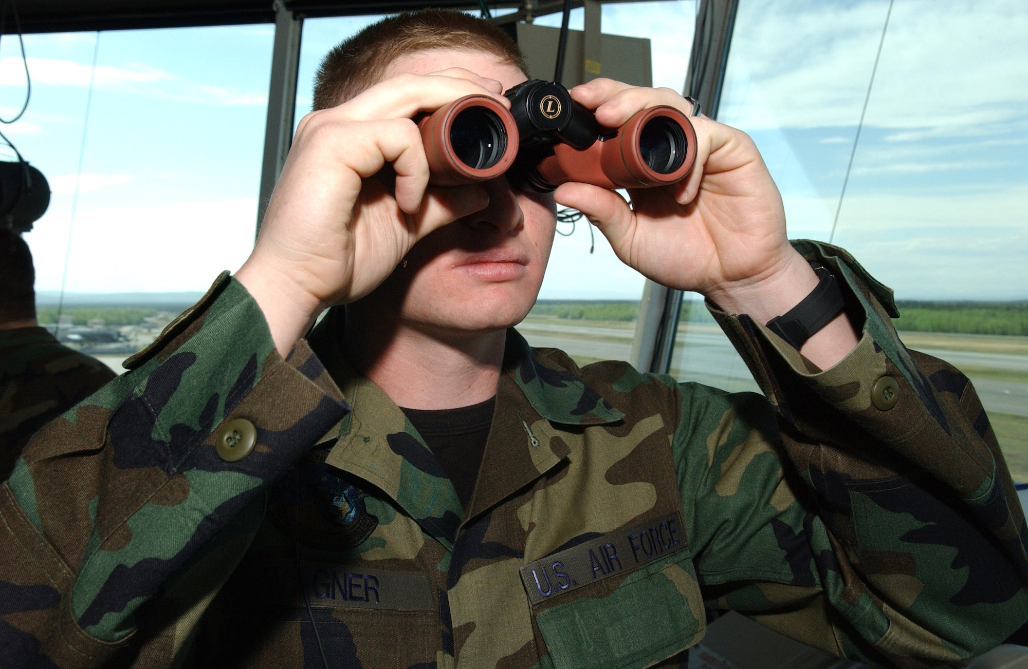 Airman 1st Class Kenneth Wagner, 354th Operations Support Squadron air traffic controller, checks for planes coming down the flightline at Eielson Air Force Base, Alaska, May 23. Airman Wagner is in charge of ground data. (U.S. Air Force photo/Airman 1st Class Christopher Griffin) 
