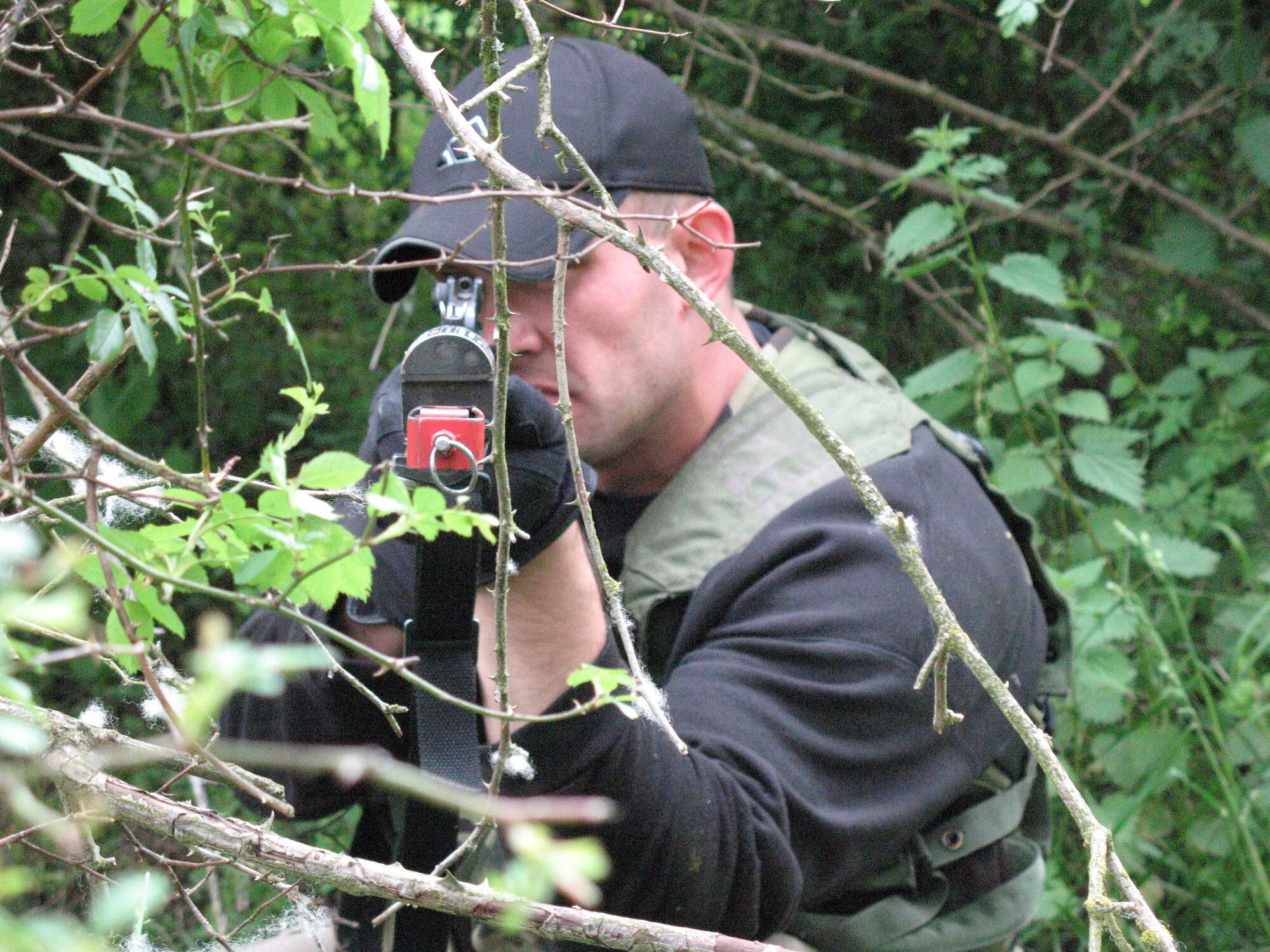 Staff Sgt. James Baylis takes aim at a convoy from a hidden position as part of Creek Defender at Baumholder, Germany. The exercise prepares security forces Airmen in U.S. Air Forces in Europe for combat situations they may face while deployed. Sergeant Baylis acts as one of several opposition forces used to test students on their reactions to threats. (U.S. Air Force photo/Staff Sgt. Lance Heinzelman) 
