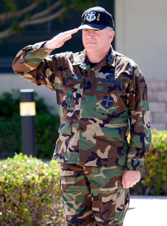 Col. Bryan Gallagher, 95th Air Base Wing commander, salutes the wing formation during his Assumption of Command ceremony at building 1 here May 29. (Photo by Mike Cassidy)