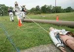 A  Team Lackland fire rescue team extracts a dummy from a ditch May 21 at Lackland Air Force Base, Texas, during a military exercise that lasted about 45 minutes. The exercise was cancelled due to real world severe weather warnings. (USAF photo by Robbin Cresswell)