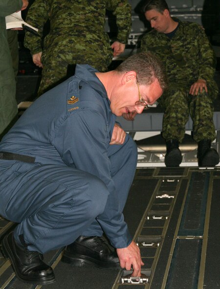 Master Cpl. Paul Gairdner, Avionics Technician with the 429th Squadron stationed at Canadian Forces Base Trenton, Ontario, practices the task of tie-down inspection on a C-17 Globemaster III cargo aircraft during a class in general aircraft familiarization at Travis AFB. The 349th Equipment Maintenance Squadron, Inspection Section facilitated the class giving hands-on training and answering questions for the team. Master Cpl. Gairdner, who is attending the six-week class with a team of avionics specialists from CFB Trenton was very enthusiastic about the training.
 “It has been very interesting working with the U.S. Air Force, and I am very happy to be part of this experience,” said Master Cpl. Gairdner. (U.S. Air Force photo by Master Sgt. Wendy Weidenhamer)
