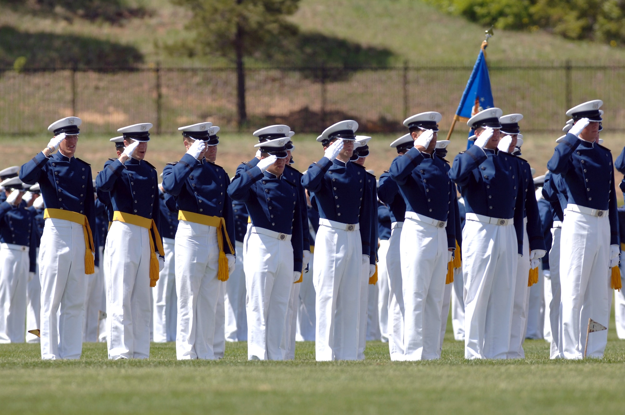 Cadets salute during the playing of the National Anthem, during the 2007 Graduation Parade May 29 at the U.S. Air Force Academy in Colorado. The graduation for the U.S. Air Force Academy's Class of 2007 will be held at 10 a.m. May 30 at Falcon Stadium. Secretary of Defense Dr. Robert M. Gates will be the guest speaker. Cadets are exposed to a balanced curriculum that provides a general and professional foundation essential to a career Air Force officer. (U.S. Air Force photo/David Armer) 
