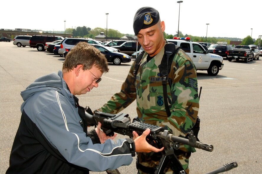 Jim  Wislotsky from Burlington, Mass., examines a rifle that Staff Sgt. Michael Choquette, 66th Security Forces Squadron, shows him during one of several Hanscom Police Week events May 16. (US Air Force Photo by Jan Abate)
 

