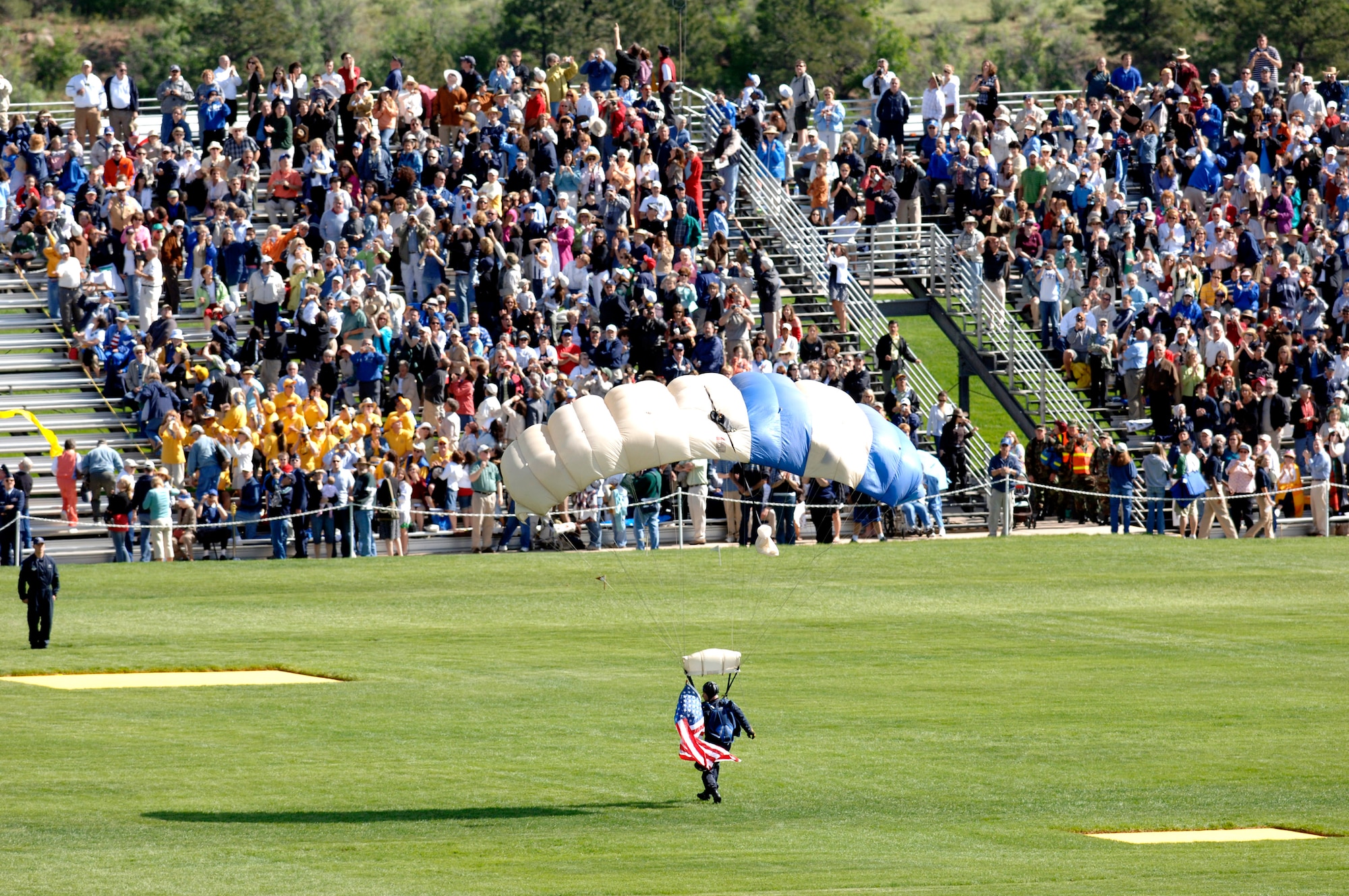 A Wings of Blue parachutist arrives on the parade field during the 2007 Graduation Parade May 29 at the U.S. Air Force Academy in Colorado. The graduation for the U.S. Air Force Academy's Class of 2007 will be held at 10 a.m. May 30 at Falcon Stadium. Secretary of Defense Dr. Robert M. Gates will be the guest speaker. Cadets are exposed to a balanced curriculum that provides a general and professional foundation essential to a career Air Force officer. (U.S. Air Force photo/Mike Kaplan) 
