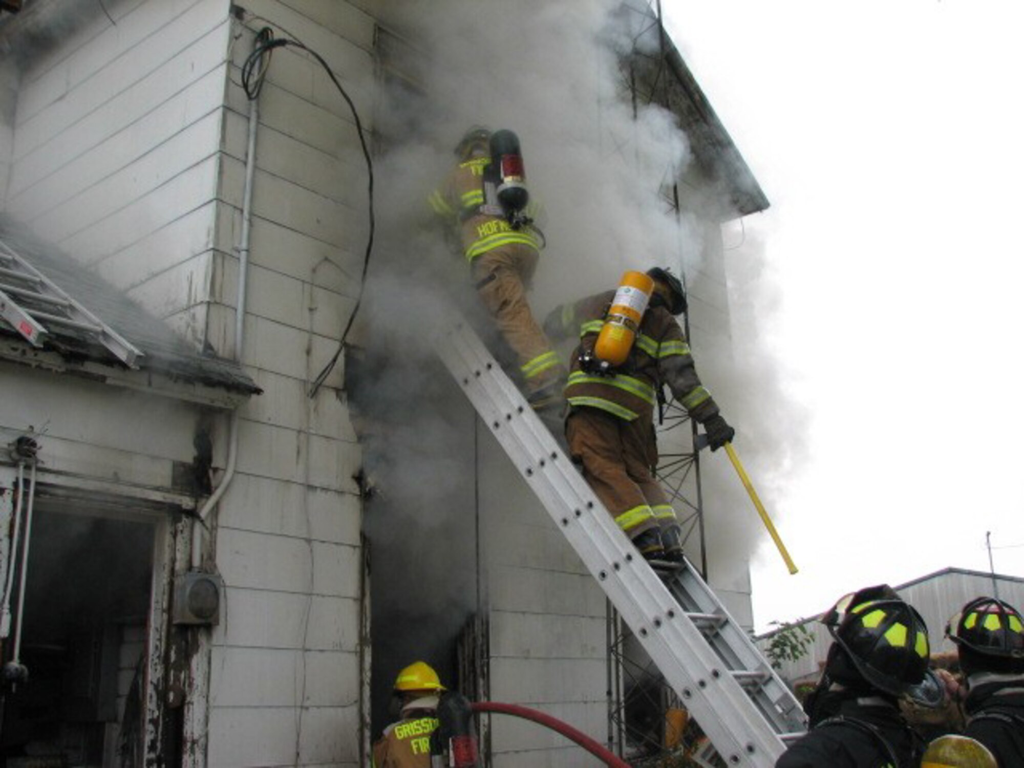 GRISSOM AIR RESERVE BASE, Ind., -- Grissom fire fighters help battle a blaze near the base recently. The house was located about 3 miles north of the base, and local fire departments requested the base's support as part of the mutal aid agreement. Several area volunteer fire departments were also on-scene to try and save the house and its contents. (U.S. Air Force photo)