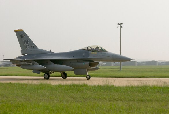 A pilot from the 80th Fighter Squadron F-16 returns to Kunsan Air Base after a week long deployment to Marine Corps Air Station Iwakuni, Japan on May 25. Pilots from the 80th FS flew dissimilar aircraft sorties as opposing forces, commonly known as red air, for Marine Corps aviators flying the F/A-18 Hornet. The sorties are valuable upgrade and continous training for pilots within the two units.  (U.S. Air Force Photo by Staff Sergeant Darcie Ibidapo.)