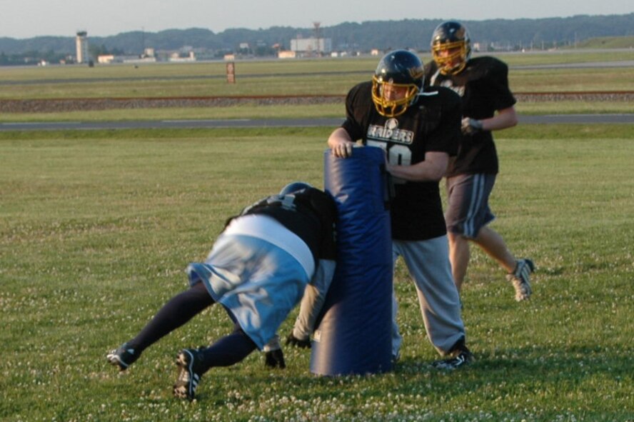 Yokota Warriors lineman Lateef Anderson, works on his lineman chopping with team mate Jeremy Jones during practice May 22 at Darling Field.