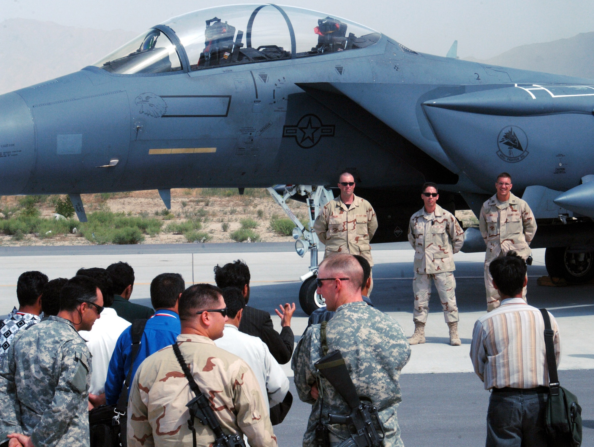 (From left to right) Staff Sgt. Kerry Pliler, Senior Master Sgt. John Felten and Capt. Rawley Mims, 455th Expeditionary Aircraft Maintenance Squadron, take questions from local Afghan media regarding the F-15E Strike Eagle during a media day at Bagram Airfield, Afghanistan May 29. The media day was aimed at informing the local reporters on the operations at Bagram and how the U.S. military is working alongside coalition partners to support and defend freedom in Afghanistan. (photo by Staff Sgt. Craig Seals)