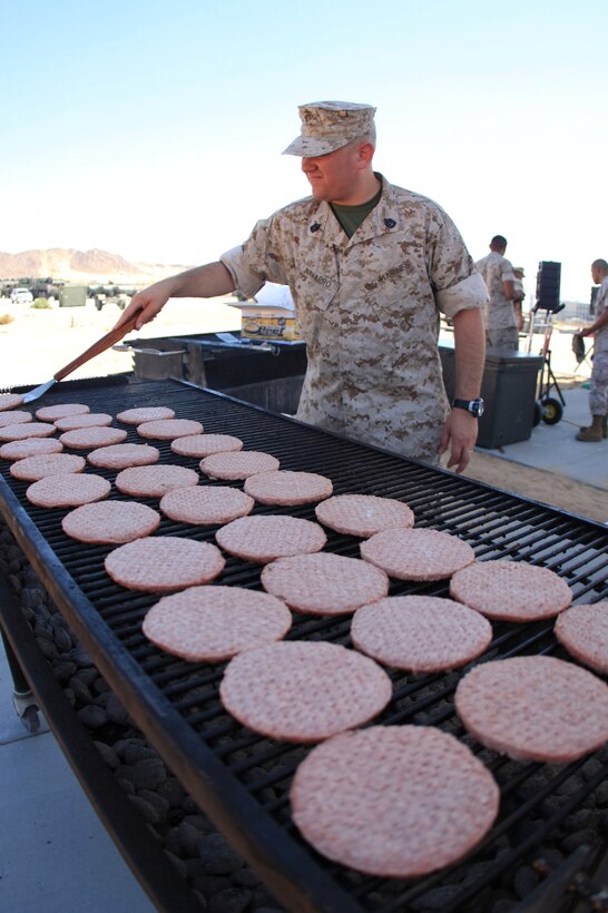 MARINE CORPS AIR GROUND COMBAT CENTER TWENTYNINE PALMS, Calif. - Gunnery Sgt. Robert Navarro, 1st Platoon commander for Company D, 4th Tank Battalion, 4th Marine Division, flips burgers during his company's family day at their headquarters building Sept. 19. The event was held to help family members learn what is available to them aboard the Combat Center