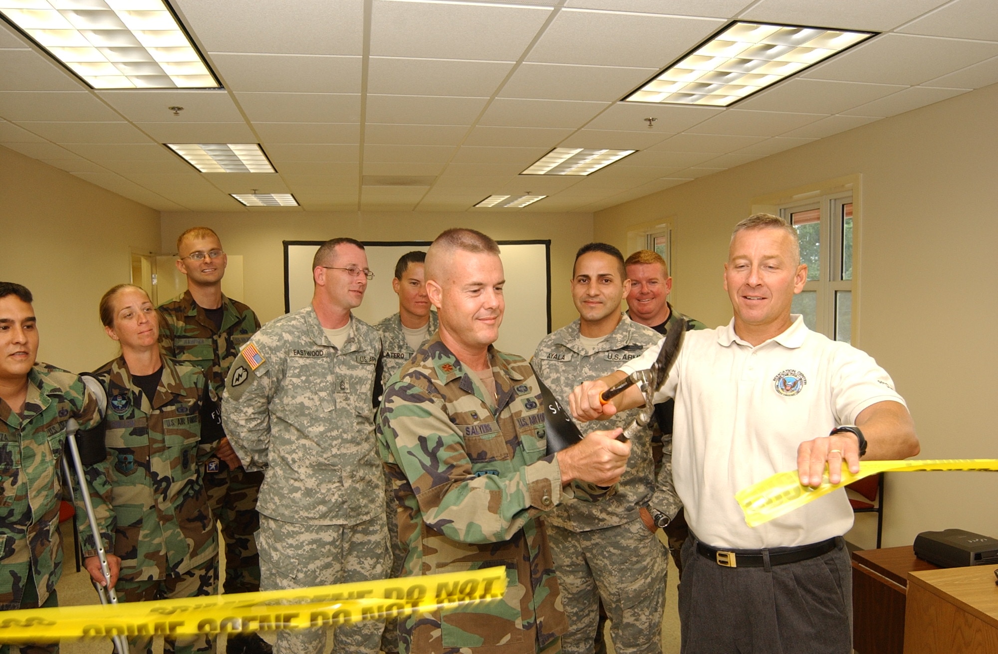 SOTO CANO AIR BASE, Honduras -- (Left) Maj. Shaun Salyers, Joint Security Forces commander, and Army Col. Christopher Hughes, Joint Task Force-Bravo commander, cut the “crime scene tape” during a ribbon cutting ceremony for the new JSF facility here May 30, 2007.  The new $730,000 facility combines offices that were previously spread out in four separate wooden buildings.  (U.S. Air Force photo/Tech. Sgt. Sonny Cohrs) 