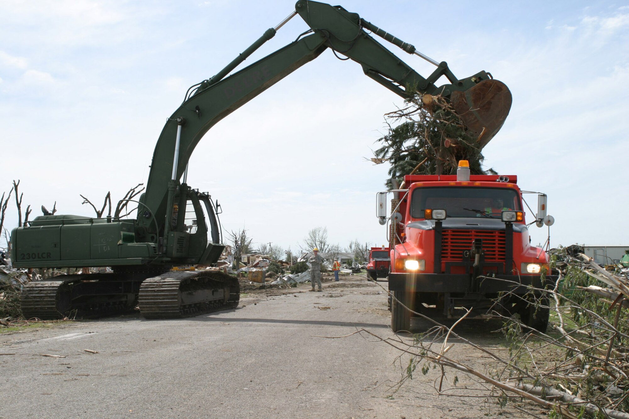 Engineers from the Kansas Army National Guard and the Kansas Department of Transportation work together to restore order to Greensburg. (Photo by Army Sgt. Heather Wright)