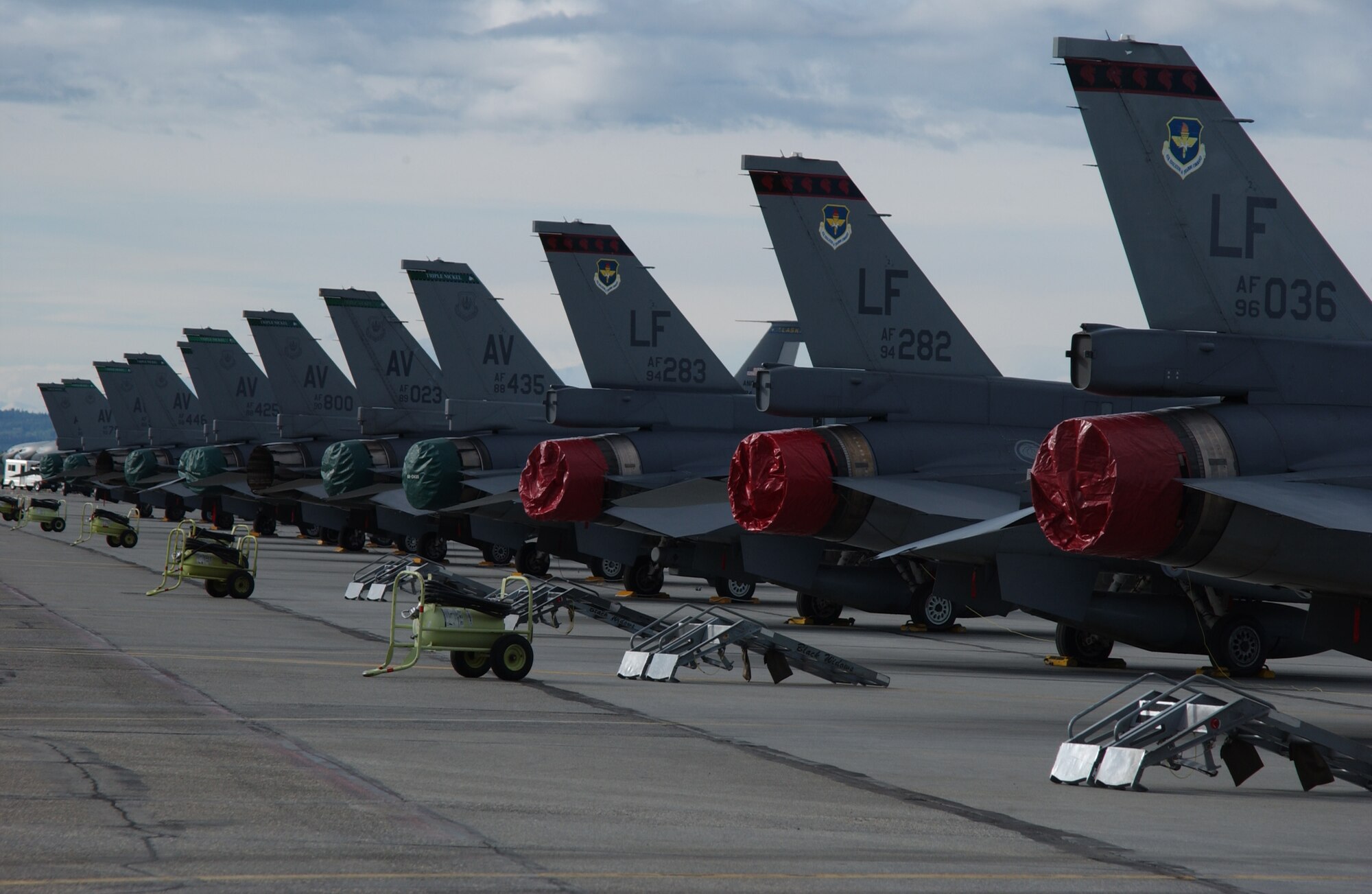 EIELSON AIR FORCE BASE, Alaska -- Three F-16s' Fighting Falcons from Republic of Singapore Air Force (Front) and Nine F-16s' Fighting Flacons from the 555th Fighter Squadron, Aviano Air Base, Italy (Back), sit on the tarmac on May 31 for Red Flag-Alaska 07-2. RF-A is a Pacific Air Forces-directed field training exercise for U.S. and coalition forces flown under simulated air-combat conditions. It is conducted on the Pacific Alaska Range Complex with air operations flown out of Eielson and Elmendorf Air Force Bases.  (U.S. Air Force Photo by Airman 1st Class Jonathan Snyder) 