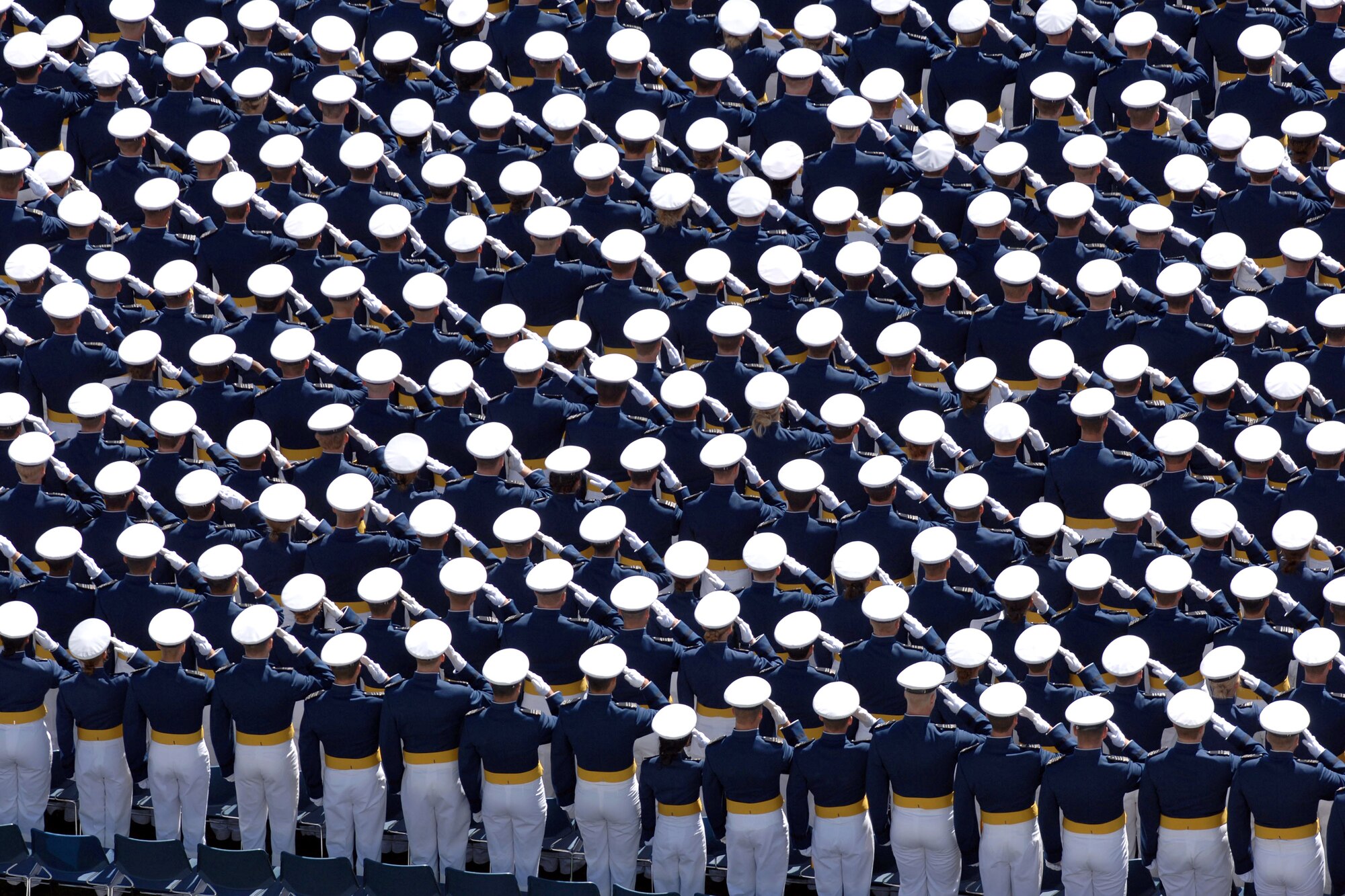 Members of the U.S. Air Force Academy Class of 2007 salute during the playing of the national anthem during the commencement ceremony May 30 in Colorado. The ceremony marks the culmination of four years at the academy and their transition from cadet to the Air Force's newest second lieutenants. (U.S. Air Force photo/David Armer) 
