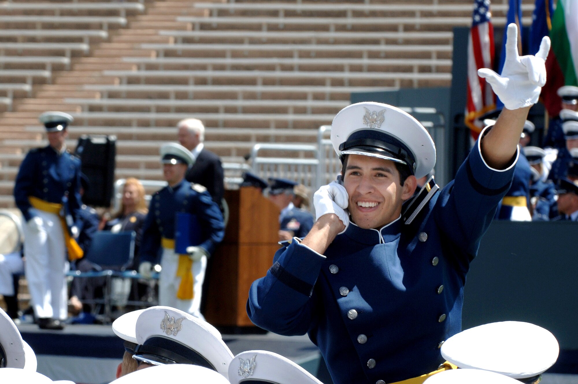 One of the Air Force's newest second lieutenants waves to the crowd after receiving his degree and commission from the U.S. Air Force Academy May 30 in Colorado. The ceremony in Falcon Stadium ends the cadet careers and begins the Air Force careers of 977 new lieutenants. (U.S. Air Force photo/Joel Strayer) 