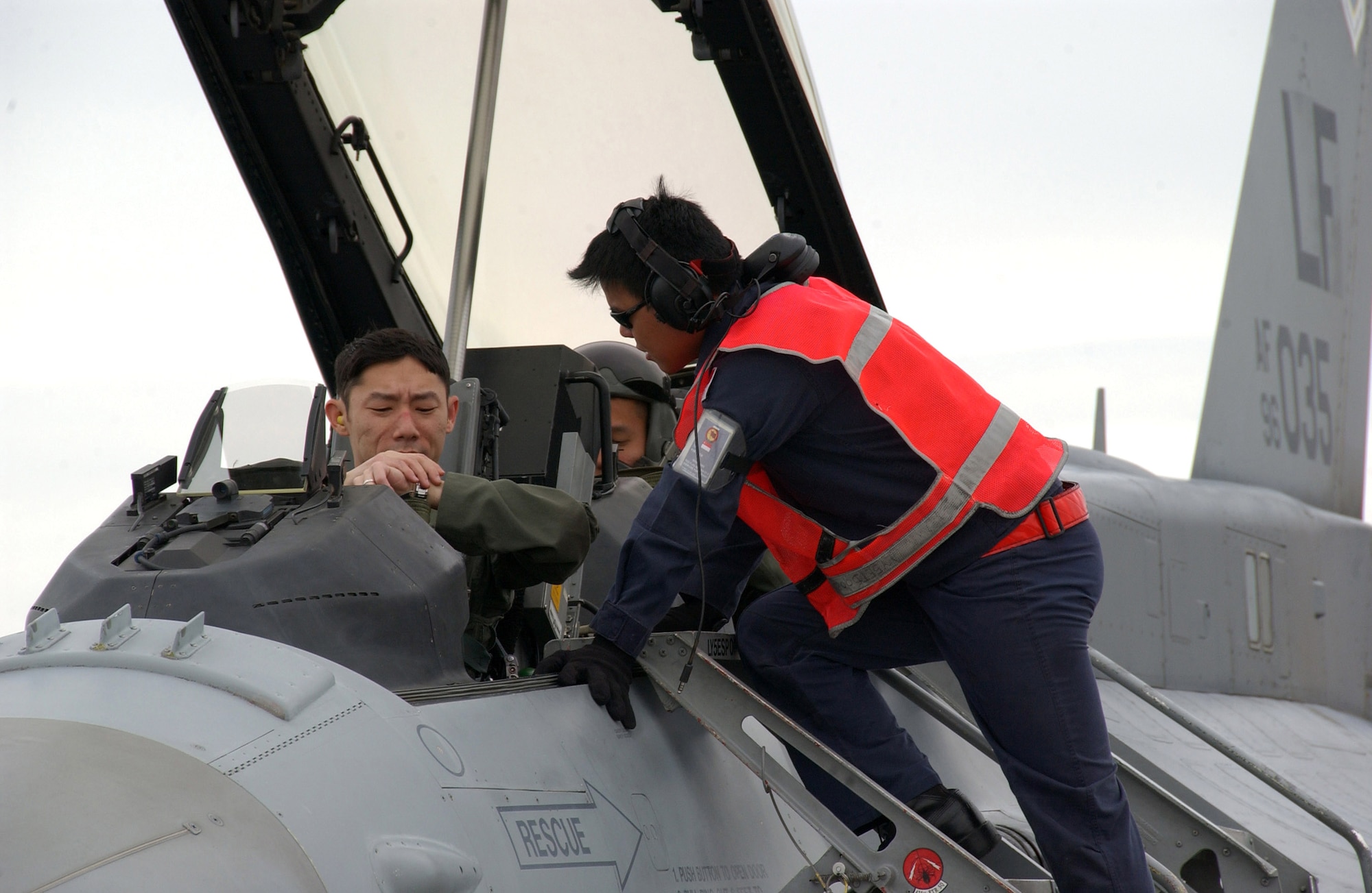 A Republic of Singapore Air Force crew chief helps two Singapore pilots complete post-flight checks after landing at Eielson Air Force Base, Alaska, May 30 for Red Flag-Alaska 07-2. (U.S. Air Force photo/Senior Airman Justin Weaver)

